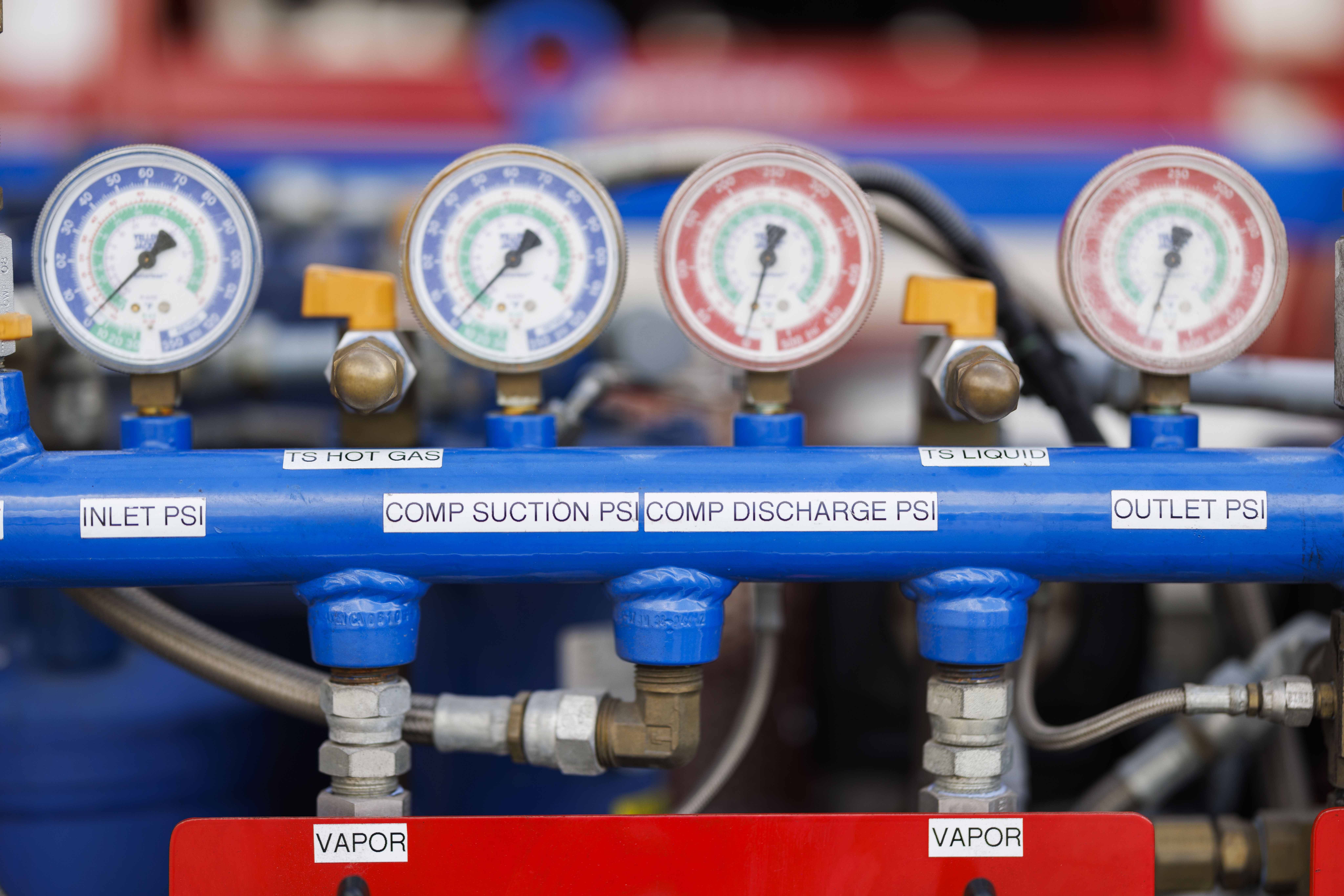 Two blue and red dials on some equipment in a warehouse