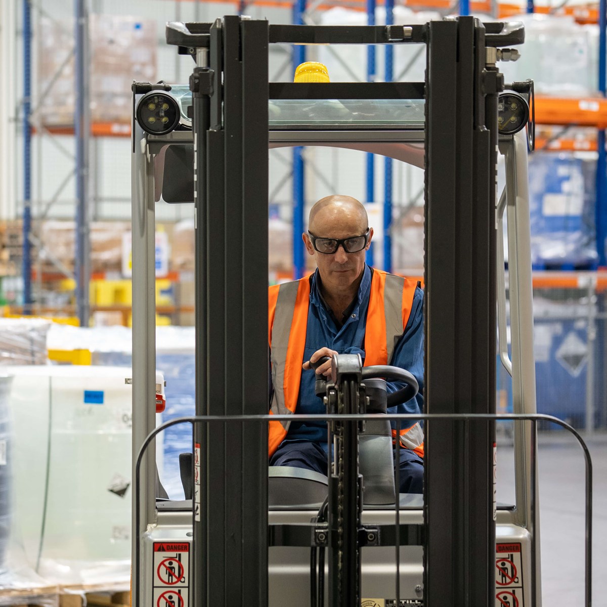 Man driving a forklift truck in a warehouse