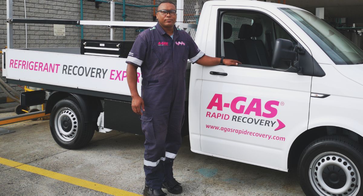 A man standing next to a white truck 