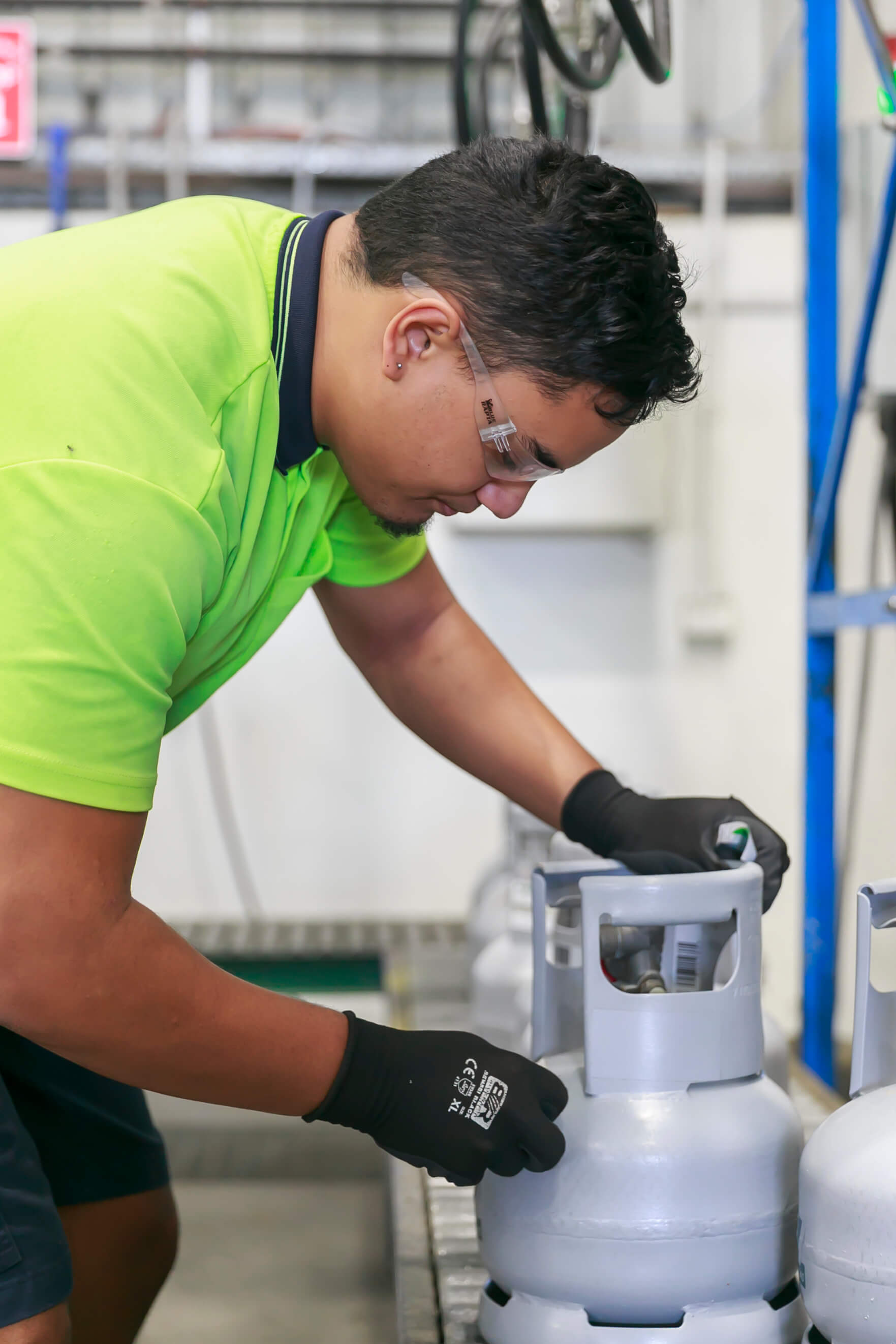 Close up of a warehouse technician working on a cylinder