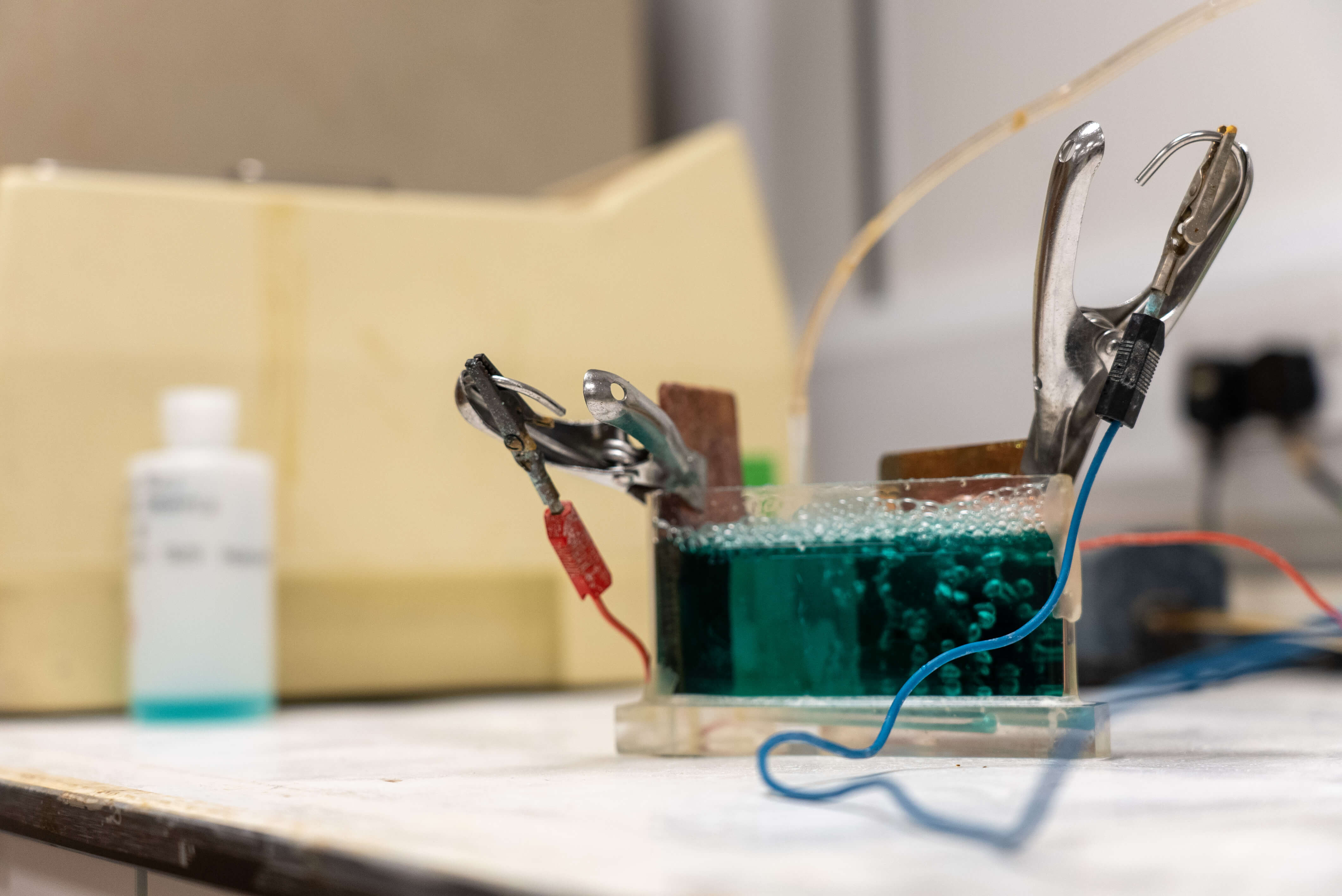 Plastic container filled with green liquid and equipment 