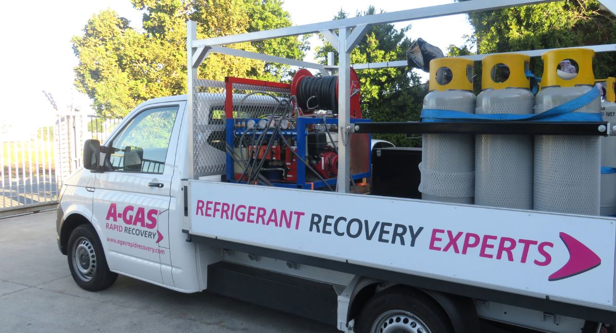 A white van with silver and yellow cylinders on the back 