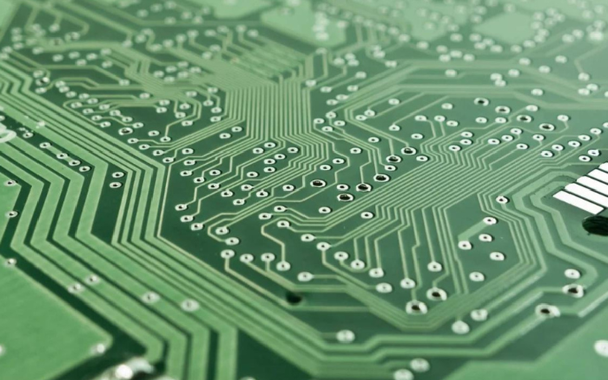 A piece of green technological hardware with a central pink circle