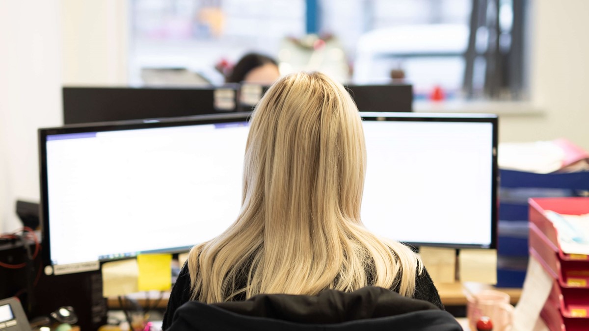 a photo of the back of a female office worker