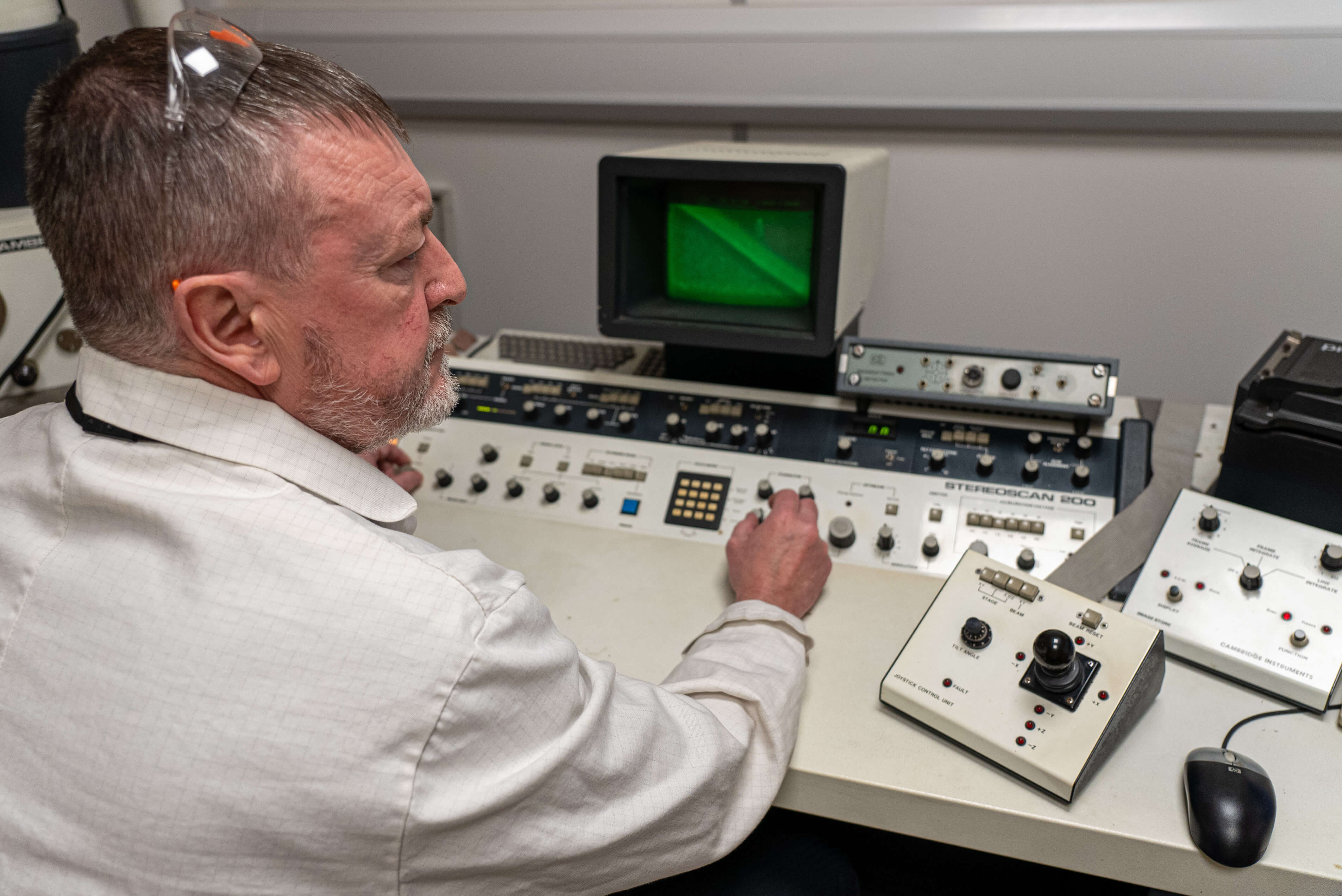 Man sat at a desk using scientific equipment 