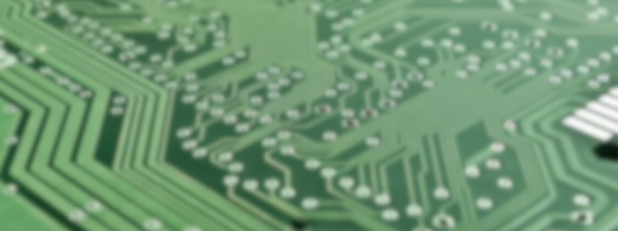 A piece of green technological hardware with a central pink circle