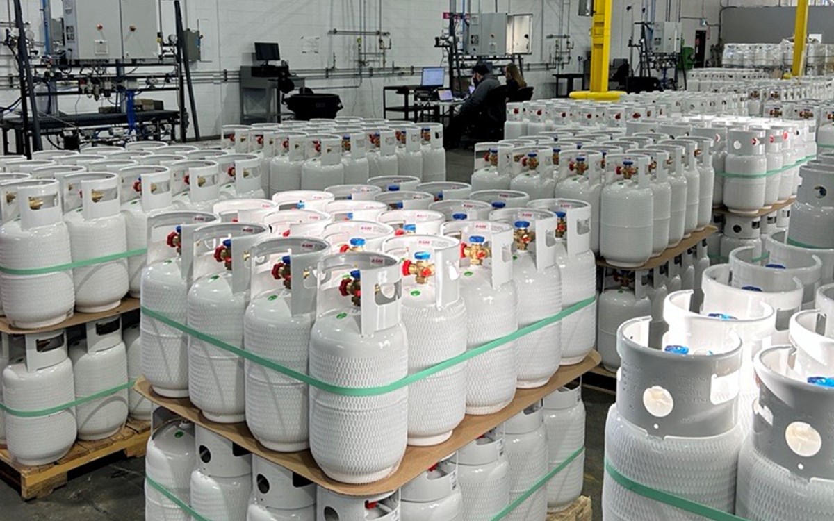 Pallets of white gas cylinders in warehouse