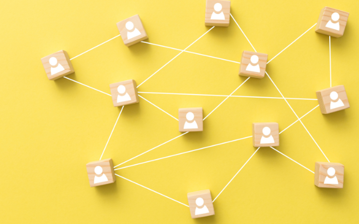 Graphic of brown wooden squares with white people icons on a yellow background