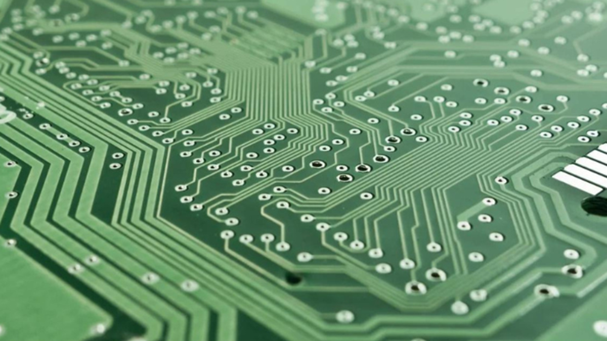 A piece of green technological hardware with a central pink circle