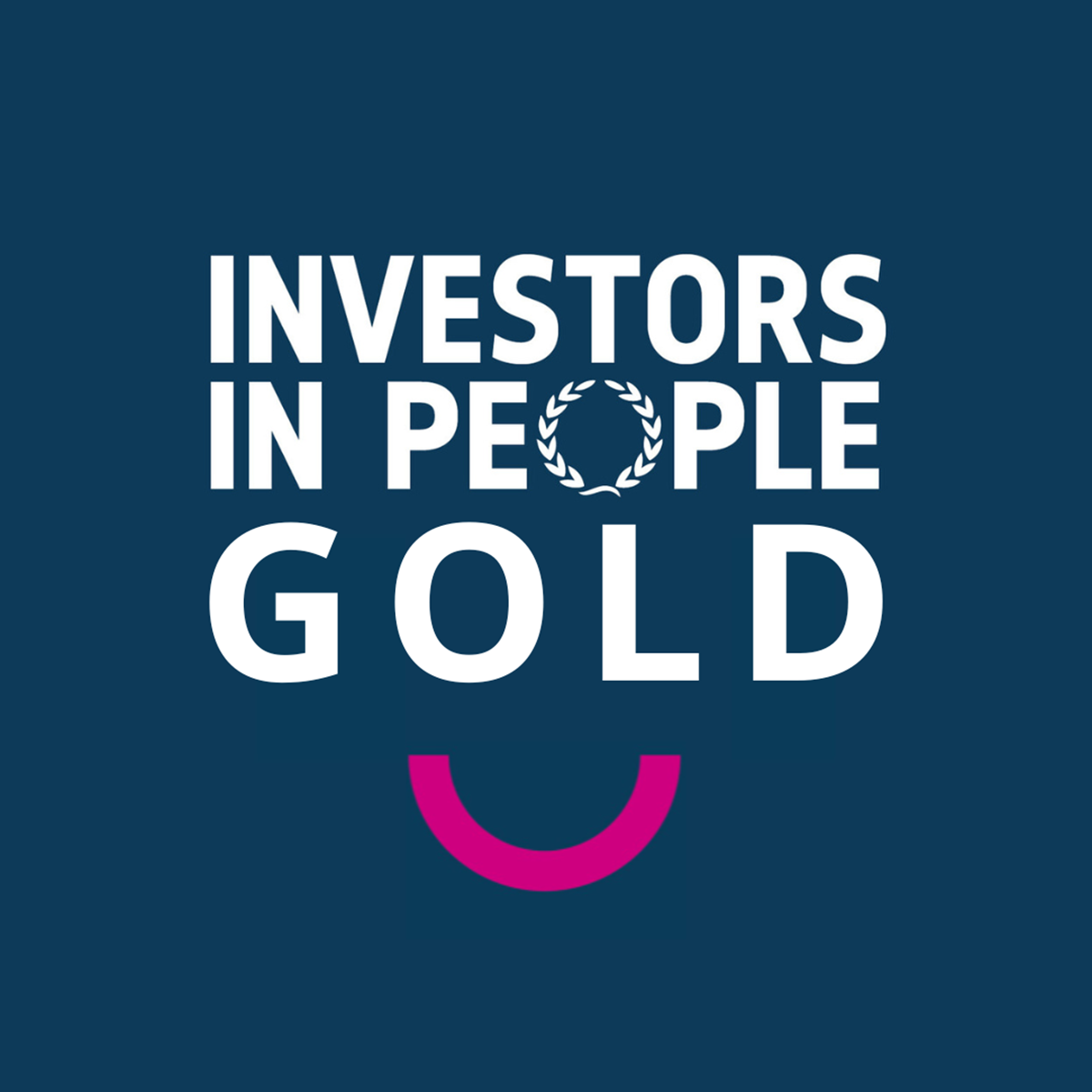 White text reading "Investors in People Gold" with a pink semicircle on a dark background